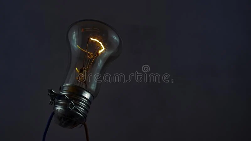 dim-light-bulb-dark-dim-light-bulb-glows-dark-against-concrete-wall-176460708.jpg