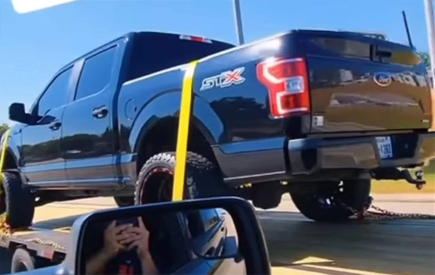Ford-F-150-STX-on-back-of-Ram-pickup-video-screenshot-003.webp